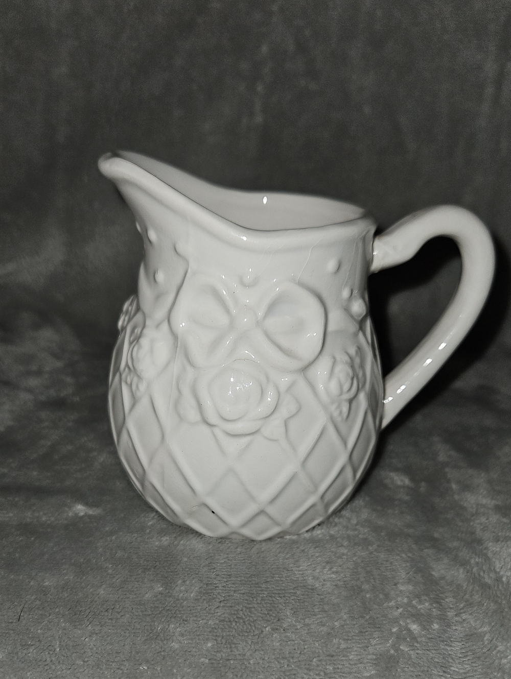 White Ceramic Decorative Pitcher with Floral Bow Motif -